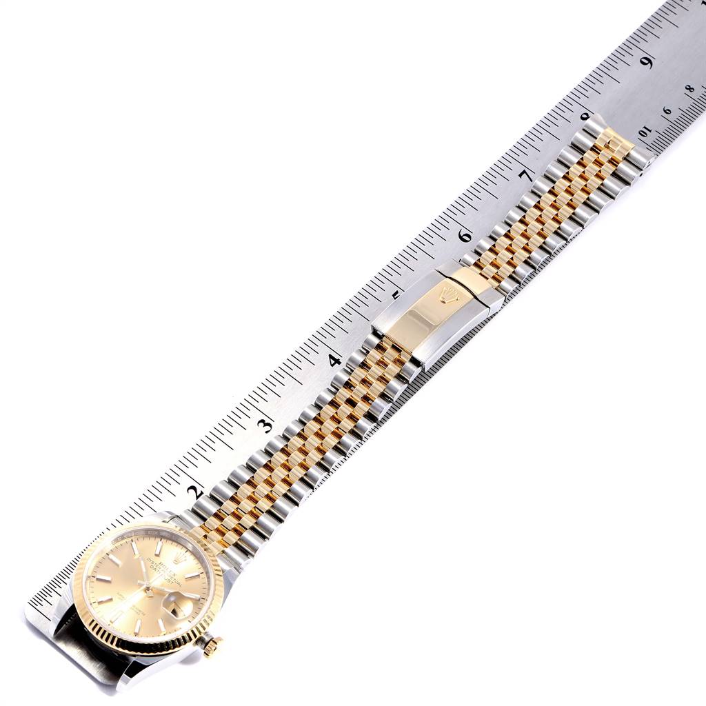 The image shows a Rolex Datejust 126233 Men's Steel and Gold (two tone) Champagne Dial 126233 Men's Steel and Gold (two tone) Champagne Dial watch laid flat next to a ruler, displaying both the watch face and the bracelet.