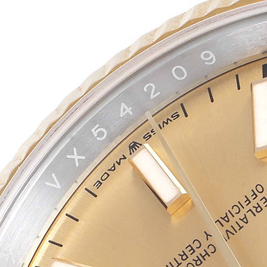 The image shows a close-up of the Rolex Datejust 126233 Men's Steel and Gold (two tone) Champagne Dial 126233 Men's Steel and Gold (two tone) Champagne Dial watch dial and part of the fluted bezel, highlighting the minute markers and serial number.