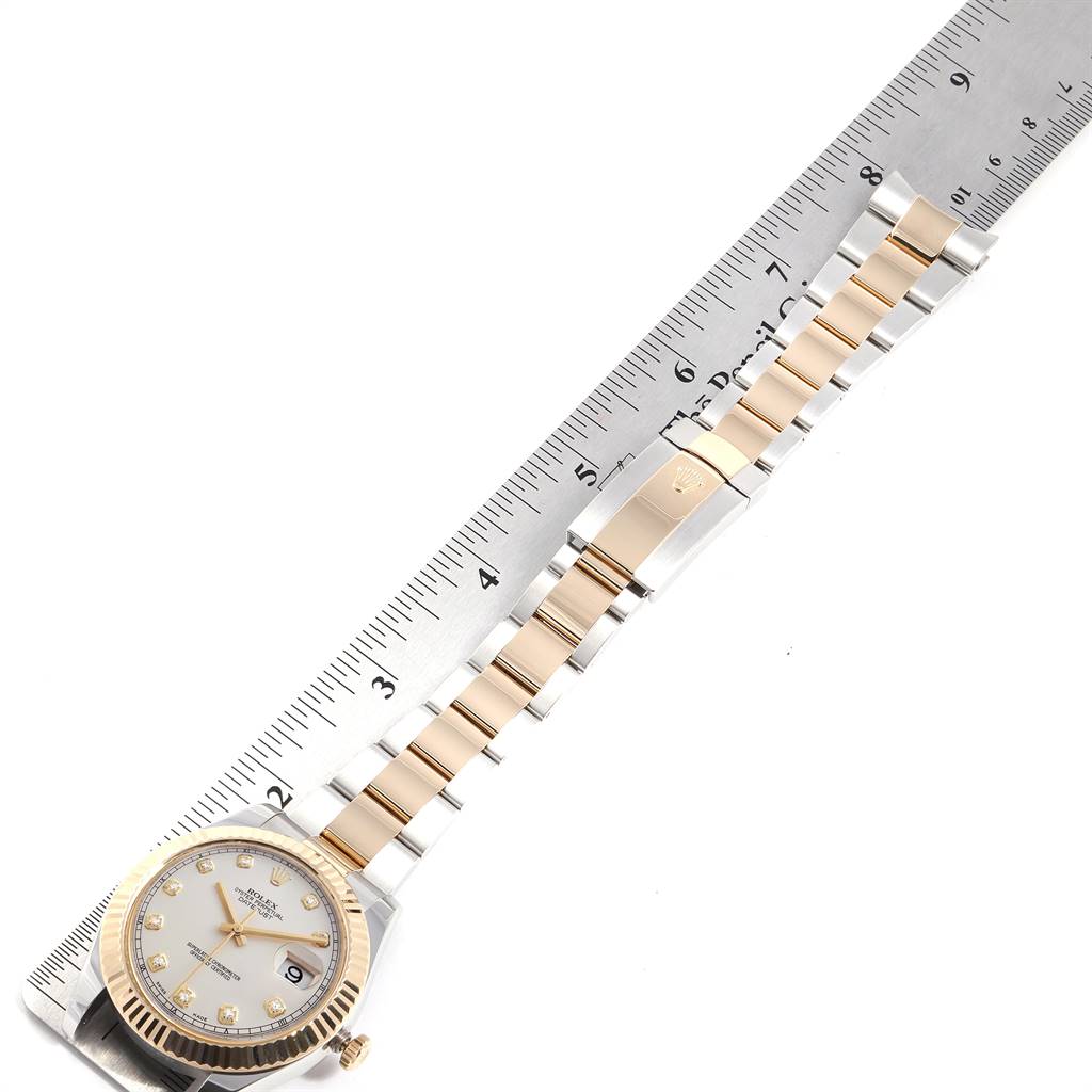 The Rolex Datejust 116333 Men's Steel and Gold (two tone) Silver Dial 116333 Men's Steel and Gold (two tone) Silver Dial watch is shown from an overhead angle, displaying the face, bracelet, and clasp against a ruler.