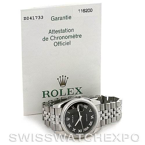 The image shows a Rolex Datejust 116200-BKRJ Men
s Stainless Steel Black Dial 116200-BKRJ Men
s Stainless Steel Black Dial watch lying flat with paperwork, including a warranty document, displayed behind it.