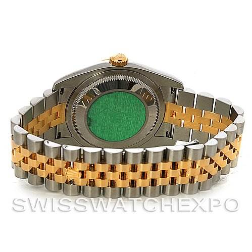 The image shows the back and bracelet of a Rolex Datejust 116203 Men's Stainless Steel Black Dial 116203 Men's Stainless Steel Black Dial watch, with a focus on the green hologram and two-tone metal band.