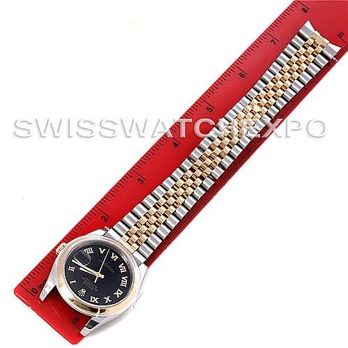 The image shows a top view of a Rolex Datejust 116203 Men's Stainless Steel Black Dial 116203 Men's Stainless Steel Black Dial watch, highlighting its black dial, two-tone metal bracelet, and part of a red measuring ruler.