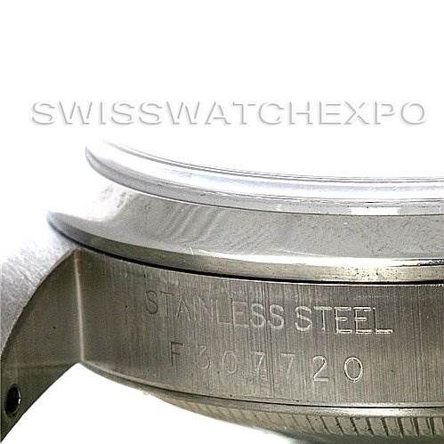The image shows a close-up of the side of a Rolex Datejust 16200 Men's Stainless Steel Black Dial 16200 Men's Stainless Steel Black Dial watch, focusing on the stainless steel bezel and engraved serial number.