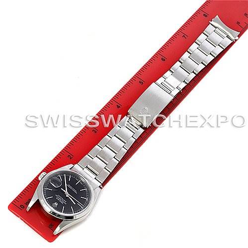 A Rolex Datejust 16200 Men's Stainless Steel Black Dial 16200 Men's Stainless Steel Black Dial watch is shown laid flat alongside a red ruler, displaying the face and full metal bracelet.