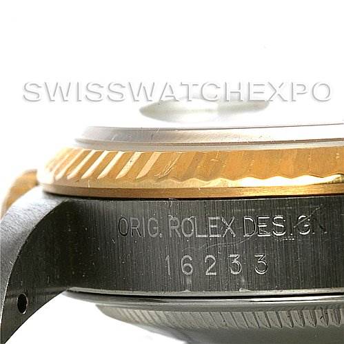 The image shows a close-up side view of a Rolex Datejust 16233 Men's Steel and Gold (two tone) Silver Dial 16233 Men's Steel and Gold (two tone) Silver Dial model watch, highlighting its bezel and inscription.