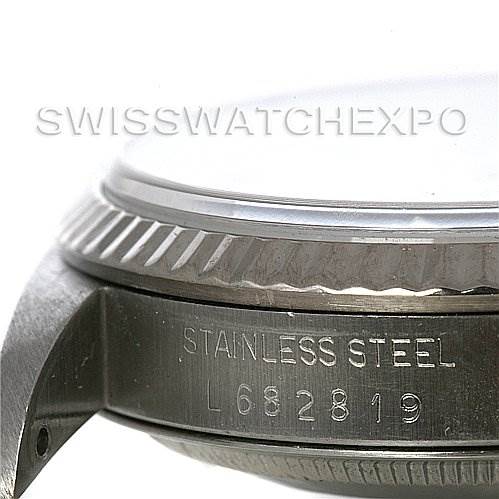 The image shows a close-up of the side of a stainless steel Rolex Datejust 16234 Men's Stainless Steel White Dial 16234 Men's Stainless Steel White Dial watch case, highlighting the bezel and serial number.