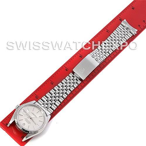 The image shows a Rolex Datejust 16234 Men's Stainless Steel Silver Dial 16234 Men's Stainless Steel Silver Dial watch laid flat with its bracelet stretched out on a red ruler.