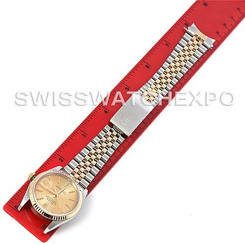 The Rolex Datejust 16233 Men's Steel and Gold (two tone) Champagne Dial 16233 Men's Steel and Gold (two tone) Champagne Dial watch is displayed at a straight angle, showing the full bracelet and face against a red ruler.