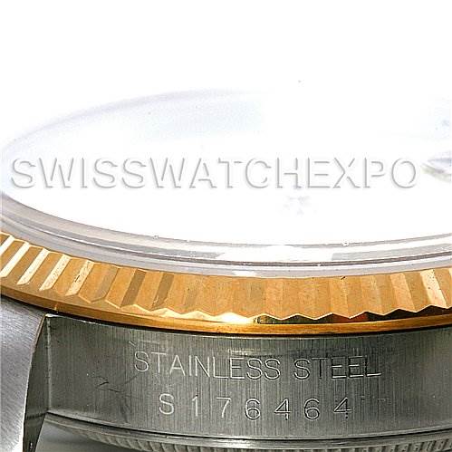 This image shows a side angle of the Rolex Datejust 16233 Men's Steel and Gold (two tone) White Dial 16233 Men's Steel and Gold (two tone) White Dial watch, highlighting the gold fluted bezel and stainless steel case with a serial number.