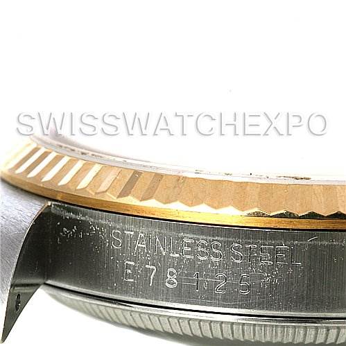 The image shows a close-up of the stainless steel case and fluted bezel of a Rolex Datejust 16233 Men's Steel and Gold (two tone) Champagne Dial 16233 Men's Steel and Gold (two tone) Champagne Dial watch, revealing part of the model's engraving.