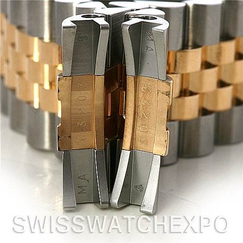 The image shows the clasp of a Rolex Datejust 116233 Men's Stainless Steel White Dial 116233 Men's Stainless Steel White Dial watch, focusing on the metal links and engraved numbers.