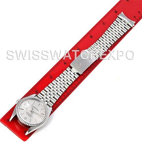 The image shows a Rolex Datejust 16220 Men's Stainless Steel Silver Dial 16220 Men's Stainless Steel Silver Dial watch laid flat, revealing the face, bezel, and full metal bracelet alongside a red ruler.