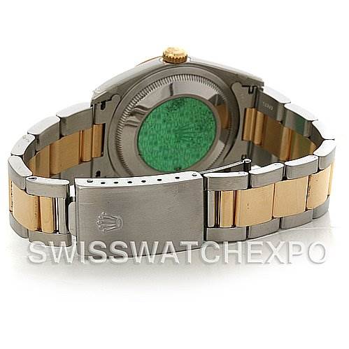 This image shows the rear view of a Rolex Datejust 16233 Men's Steel and Gold (two tone) Beige Dial 16233 Men's Steel and Gold (two tone) Beige Dial, featuring the case back, bracelet, and clasp with a green sticker.