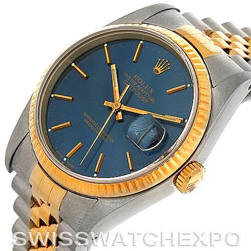 This image shows a Rolex Datejust 16233 Men's Steel and Gold (two tone) Blue Dial 16233 Men's Steel and Gold (two tone) Blue Dial watch at an oblique angle, highlighting its blue dial, gold hour markers, and two-tone bracelet.