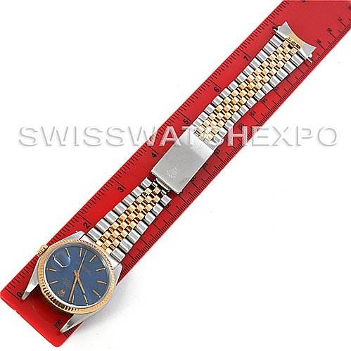 The image shows a Rolex Datejust 16233 Men's Steel and Gold (two tone) Blue Dial 16233 Men's Steel and Gold (two tone) Blue Dial watch laid flat with its strap extended and measured against a red ruler.
