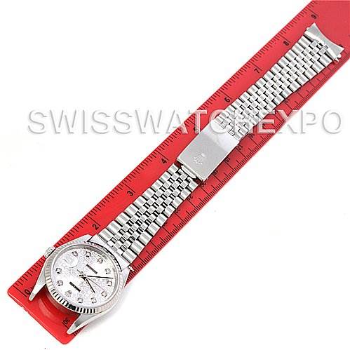 The Rolex Datejust 16234 Men's Stainless Steel Silver Dial 16234 Men's Stainless Steel Silver Dial watch is shown laid down flat on a red ruler, displaying the face, case, bracelet, and clasp.