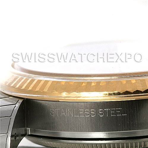 The image shows a close-up view of the side of a Rolex Datejust 116233 Men
s Stainless Steel Champagne Dial 116233 Men
s Stainless Steel Champagne Dial watch, highlighting the stainless steel and gold bezel.