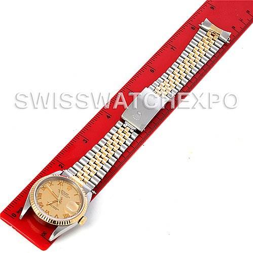 Angled view of a Rolex Datejust 16233 Men's Steel and Gold (two tone) Champagne Dial 16233 Men's Steel and Gold (two tone) Champagne Dial watch showing the face, bezel, and Jubilee bracelet, with a red ruler for scale.