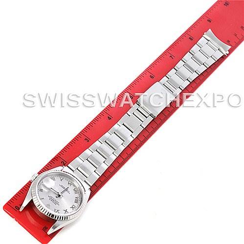 This top-down image shows the full length of a Rolex Datejust 16234 Men's Stainless Steel Grey Dial 16234 Men's Stainless Steel Grey Dial watch, including its bracelet, laying on a red ruler.