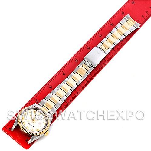 This image shows a Rolex Datejust 16233 Men's Steel and Gold (two tone) Beige Dial 16233 Men's Steel and Gold (two tone) Beige Dial watch from a top-down angle, highlighting the bracelet and watch face next to a red ruler.