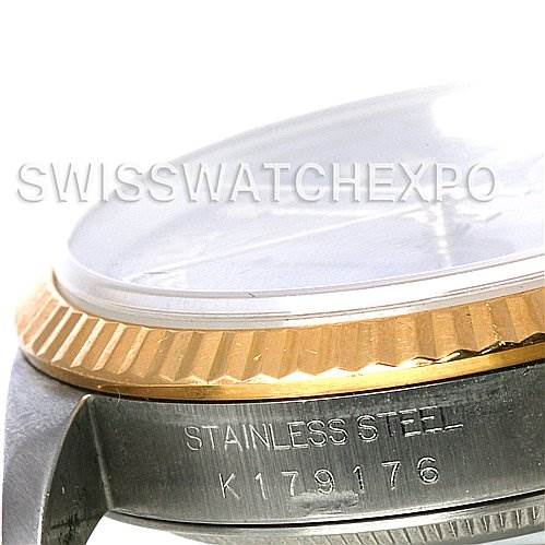This image shows a close-up angle of the side of a Rolex Datejust 16233 Men's Steel and Gold (two tone) Grey Dial 16233 Men's Steel and Gold (two tone) Grey Dial watch, focusing on the stainless steel case, serial number, and fluted bezel.