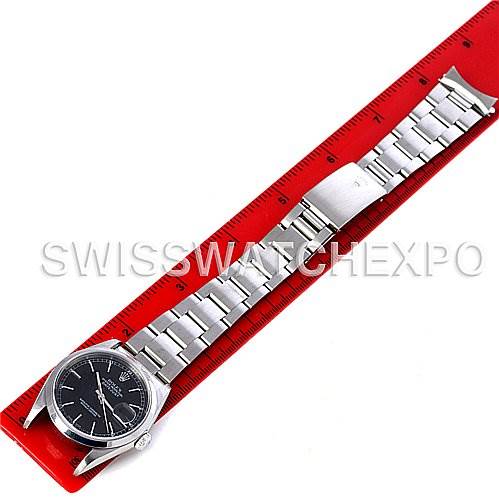 The Rolex Datejust 16200 Men's Stainless Steel Black Dial 16200 Men's Stainless Steel Black Dial watch is shown from a top-down angle, displaying the face, bracelet, and clasp, with a red ruler for scale.