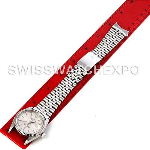 The image shows a top view of a Rolex Datejust 16234 Men's Stainless Steel Silver Dial 16234 Men's Stainless Steel Silver Dial watch with a red ruler for scale.