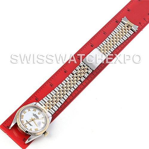 The image shows a top-down view of a Rolex Datejust 16233 Men's Steel and Gold (two tone) White Dial 16233 Men's Steel and Gold (two tone) White Dial watch laid next to a red ruler.