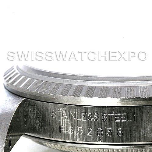 The image shows a close-up of the side of a Rolex Datejust 16220 Men's Stainless Steel Blue Dial 16220 Men's Stainless Steel Blue Dial watch casing, focusing on the stainless steel case and serial number.