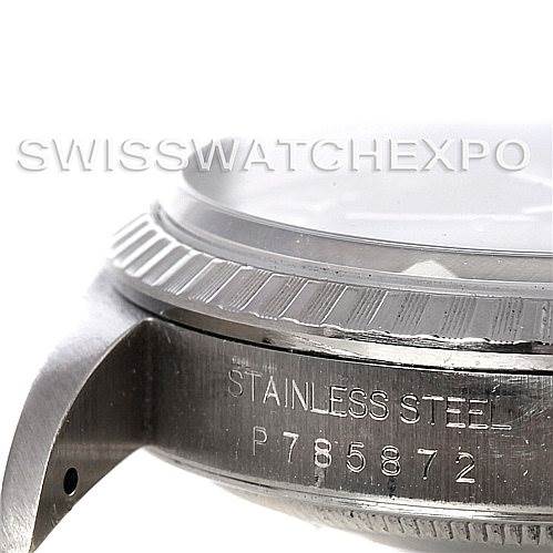 This image shows a close-up of the side of a Rolex Datejust 16220 Men's Stainless Steel Blue Dial 16220 Men's Stainless Steel Blue Dial watch case, highlighting the stainless steel material and serial number.
