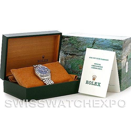 The image shows a Rolex Datejust 16220 Men's Stainless Steel Blue Dial 16220 Men's Stainless Steel Blue Dial watch inside a display box with accompanying certification and warranty booklets.
