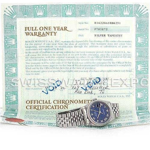 This image shows a Rolex Datejust 16220 Men's Stainless Steel Blue Dial 16220 Men's Stainless Steel Blue Dial watch with a blue dial, positioned on top of an official chronometer certification and warranty paperwork.