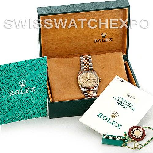 The Rolex Datejust 16233 Men's Steel and Gold (two tone) Champagne Dial 16233 Men's Steel and Gold (two tone) Champagne Dial watch is displayed in its box, with accompanying certification, a booklet, and a hang tag shown.