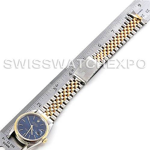 The image shows a Rolex Datejust 16233 Men's Steel and Gold (two tone) Blue Dial 16233 Men's Steel and Gold (two tone) Blue Dial watch laid flat with a ruler beside it, displaying the bracelet and dial at an overhead angle.
