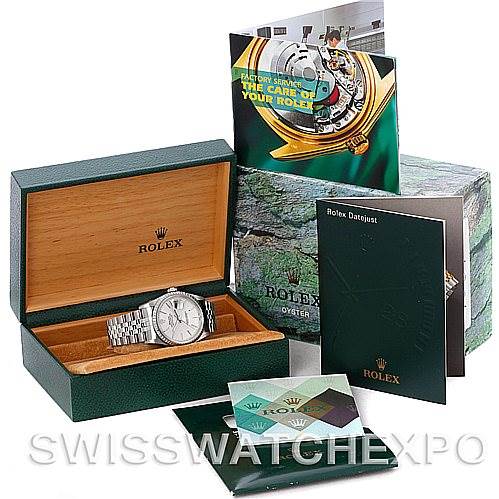 The image shows a Rolex Datejust 16220 Men's Stainless Steel Silver Dial 16220 Men's Stainless Steel Silver Dial watch, its box, user manuals, and other informational booklets from a front angle.