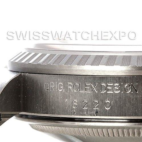 The image shows a close-up of the side of a Rolex Datejust 16220 Men's Stainless Steel Silver Dial 16220 Men's Stainless Steel Silver Dial watch case, featuring the engraved model number 16220 and the fluted bezel.