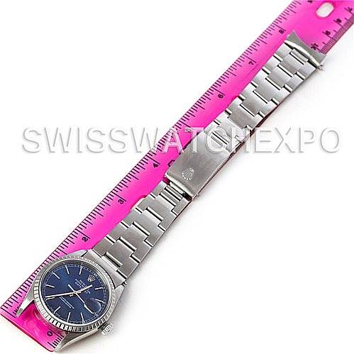 The Rolex Datejust 16220 Men's Stainless Steel Blue Dial 16220 Men's Stainless Steel Blue Dial watch is shown laid flat with its bracelet extended next to a ruler.