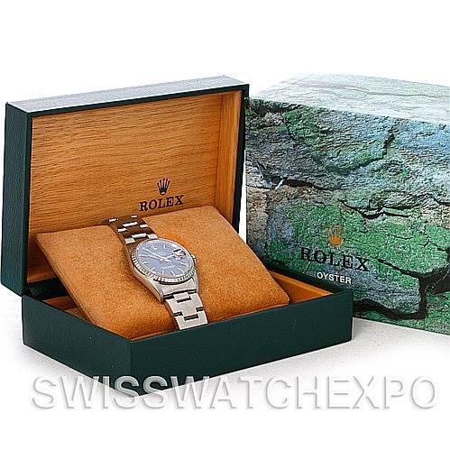 The image shows a Rolex Datejust 16220 Men's Stainless Steel Blue Dial 16220 Men's Stainless Steel Blue Dial watch at an angle displaying its face and bracelet, nestled in its branded box.