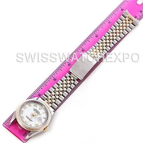 The image shows a top-view angle of a Rolex Datejust 16233 Men's Steel and Gold (two tone) White Dial 16233 Men's Steel and Gold (two tone) White Dial watch with a two-tone metal bracelet alongside a ruler for scale.