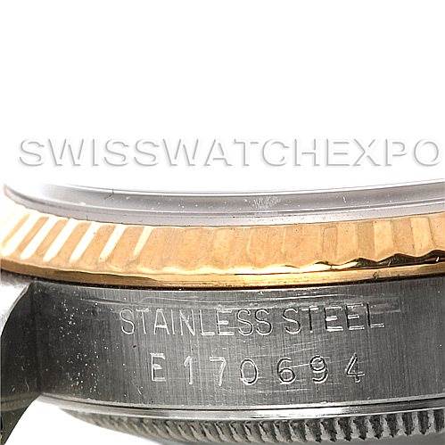 The image shows a close-up of the stainless steel case, fluted bezel, and parts of the serial engraving on a Rolex Datejust 16233 Men's Steel and Gold (two tone) Black Dial 16233 Men's Steel and Gold (two tone) Black Dial.