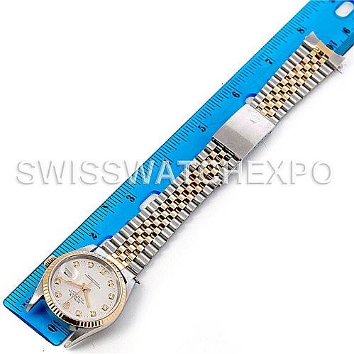 The image shows a Rolex Datejust 16233 Men's Steel and Gold (two tone) Silver Dial 16233 Men's Steel and Gold (two tone) Silver Dial watch laid flat next to a blue ruler, displaying the face, bracelet, and clasp.