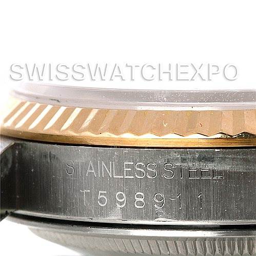 This image shows a close-up angle of the Rolex Datejust 16233 Men's Steel and Gold (two tone) Silver Dial 16233 Men's Steel and Gold (two tone) Silver Dial watch bezel and side casing with the serial number and "Stainless Steel" marked.