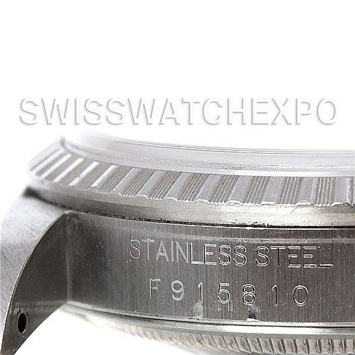 This image shows the side view of the stainless steel case of a Rolex Datejust 16220 Men's Stainless Steel Silver Dial 16220 Men's Stainless Steel Silver Dial watch, featuring part of the bezel and the serial number.