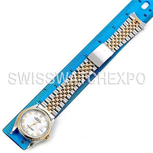 The image shows a Rolex Datejust 16233 Men's Steel and Gold (two tone) White Dial 16233 Men's Steel and Gold (two tone) White Dial watch laid flat with its bracelet extended next to a blue ruler for measurement.