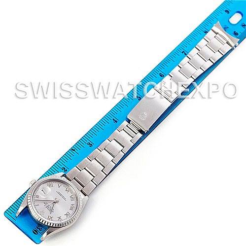 This image shows a top-down view of a Rolex Datejust 16220 Men's Stainless Steel Silver Dial 16220 Men's Stainless Steel Silver Dial watch placed next to a blue ruler.