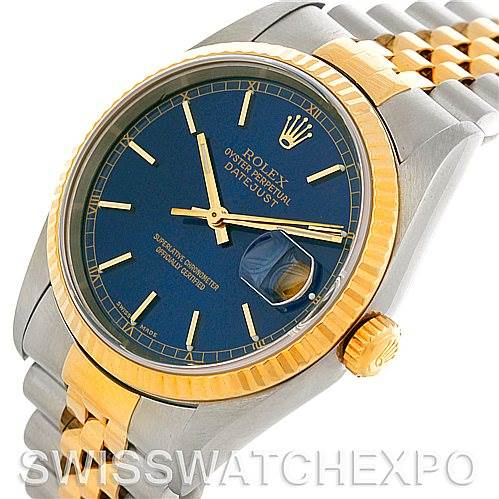 The Rolex Datejust 16233 Men's Steel and Gold (two tone) Blue Dial 16233 Men's Steel and Gold (two tone) Blue Dial watch is shown at an angled close-up, highlighting its blue dial, gold bezel, and two-tone bracelet.