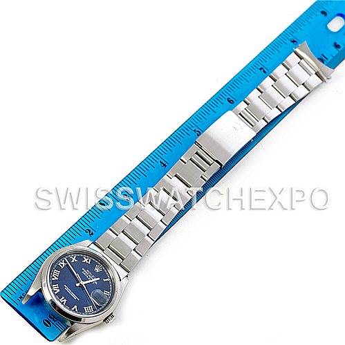 The image shows a top-down view of a Rolex Datejust 16200 Men's Stainless Steel Blue Dial 16200 Men's Stainless Steel Blue Dial watch with a blue dial and its stainless steel bracelet extended next to a ruler.