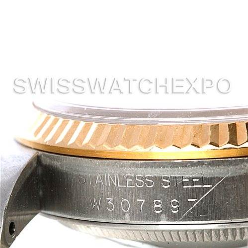 This image shows a close-up side view of the Rolex Datejust 16233 Men's Steel and Gold (two tone) White Dial 16233 Men's Steel and Gold (two tone) White Dial watch, highlighting the fluted bezel and part of the case with engraved serial number.