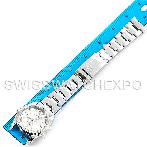 The Rolex Datejust 116234 Men's Stainless Steel Silver Dial 116234 Men's Stainless Steel Silver Dial watch is shown laid flat alongside a blue ruler for measurement.