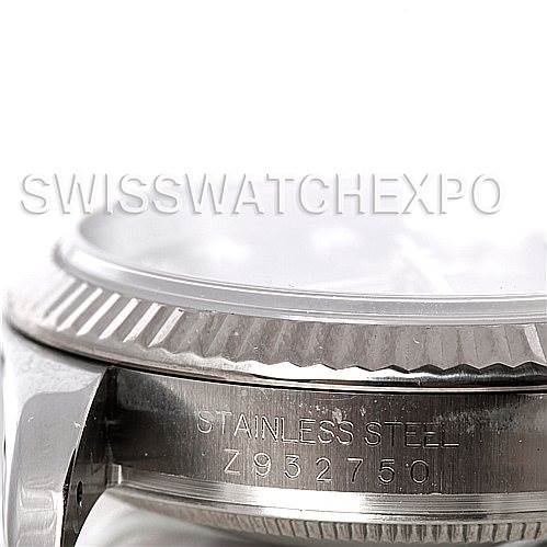The image shows a close-up of the side view of a Rolex Datejust 116234 Men's Stainless Steel Blue Dial 116234 Men's Stainless Steel Blue Dial watch, focusing on the bezel and serial number.